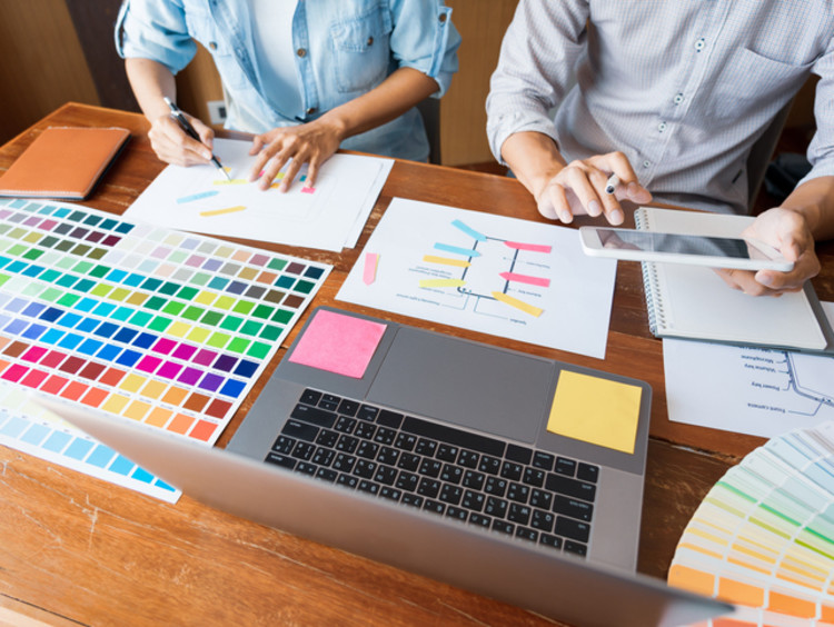 two graphic designers working on a website redesign