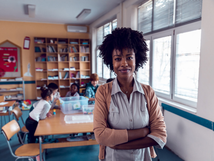 teacher standing in the front of her classroom before class starts