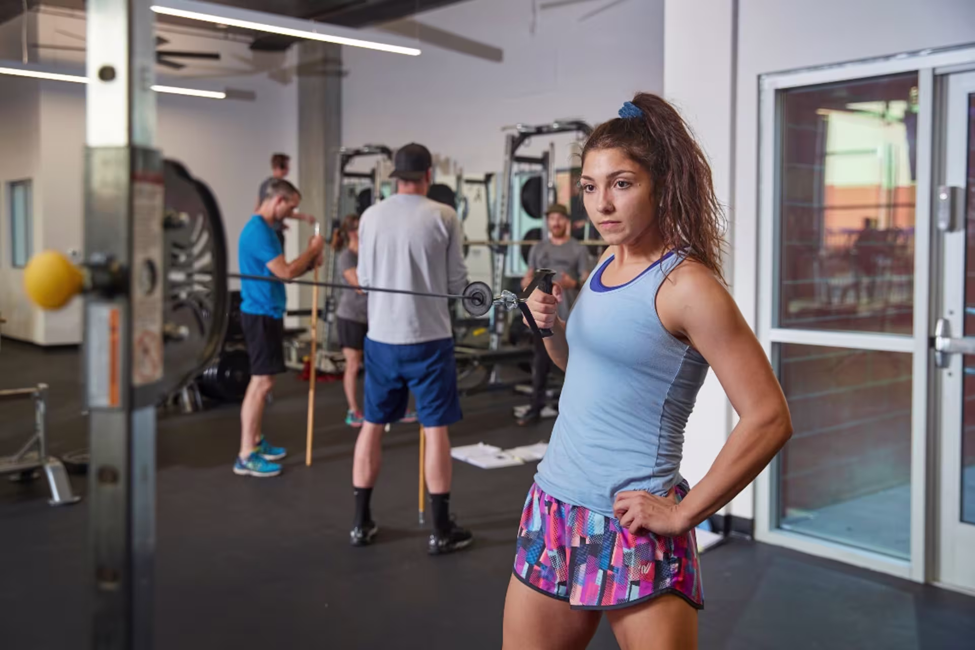 GCU student working out in the gym in tank top and shorts