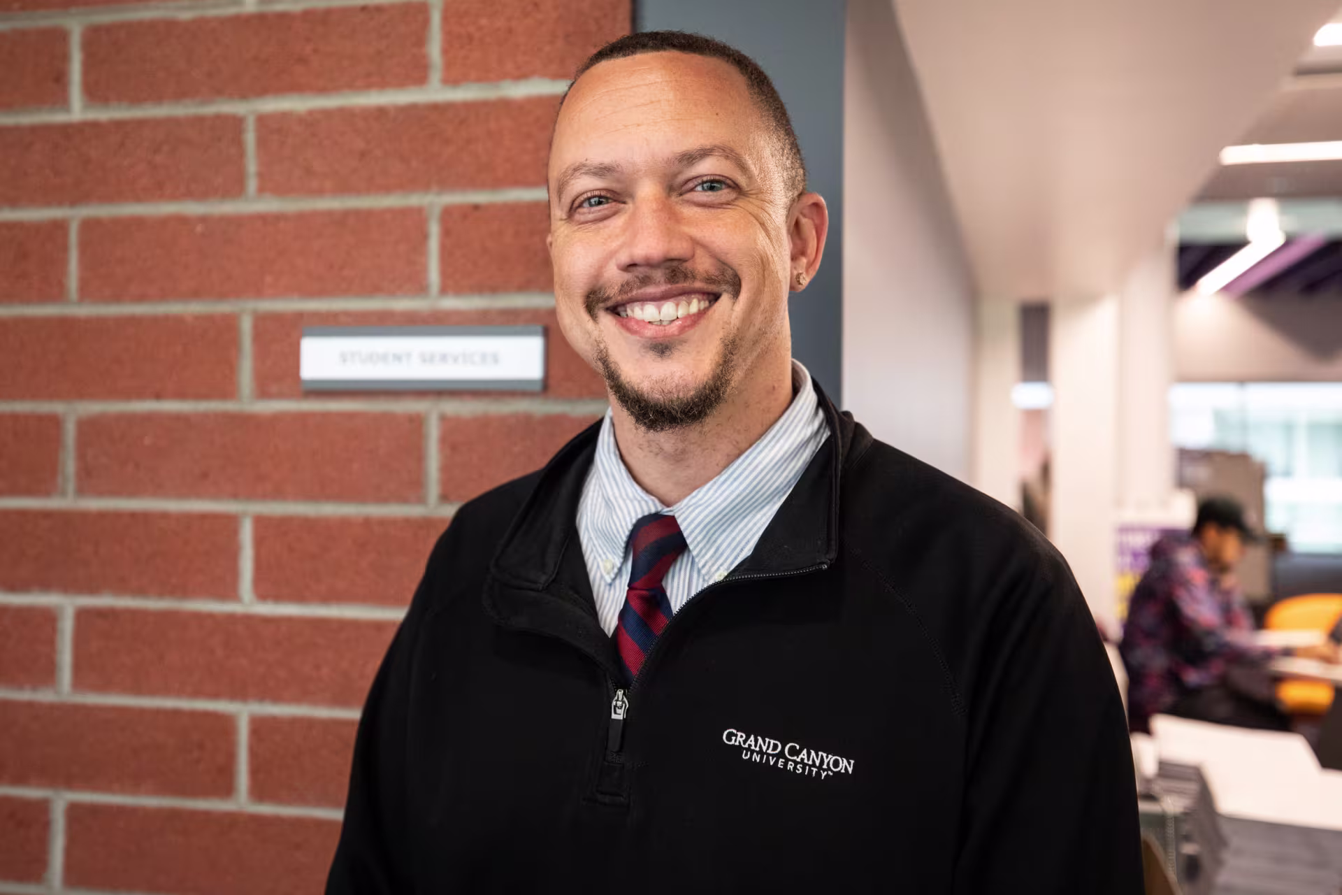 male PhD psychology student outside office