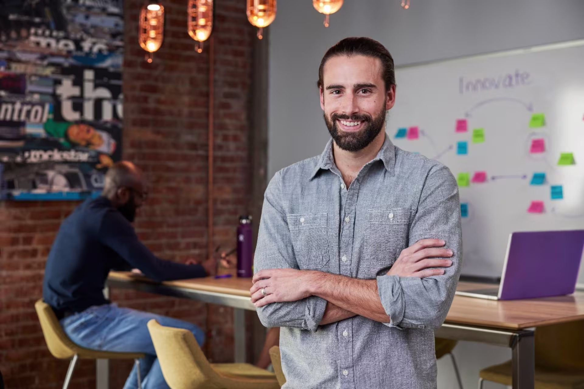 Entrepreneurship student standing n front of whiteboard that reads “innovation”