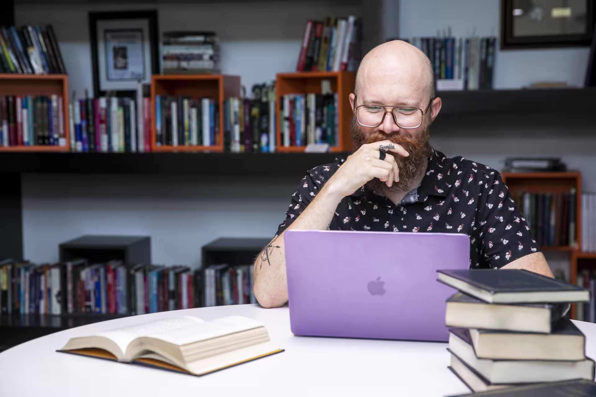 male teacher at desk on laptop