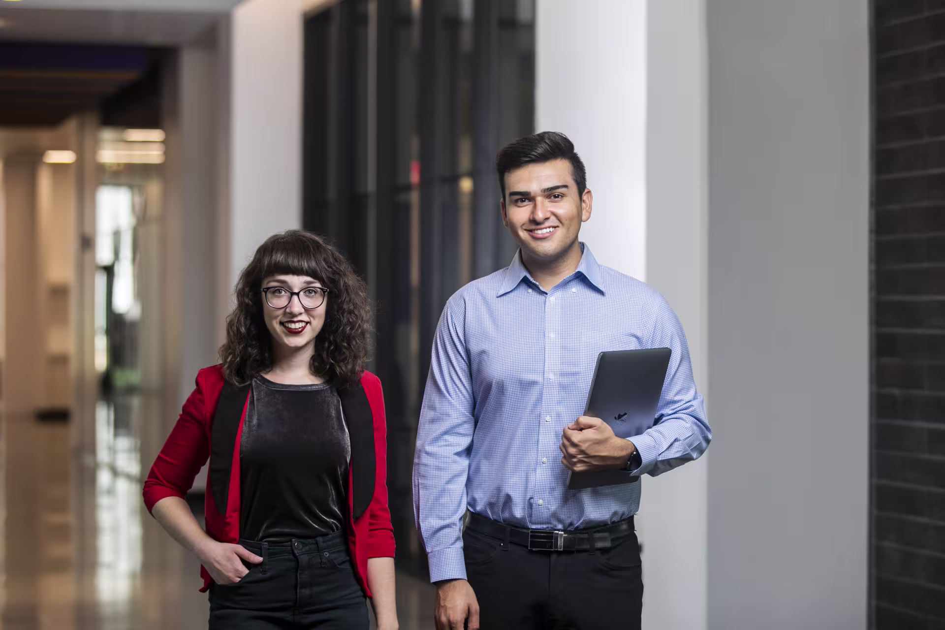 male female teachers smiling posing hallway