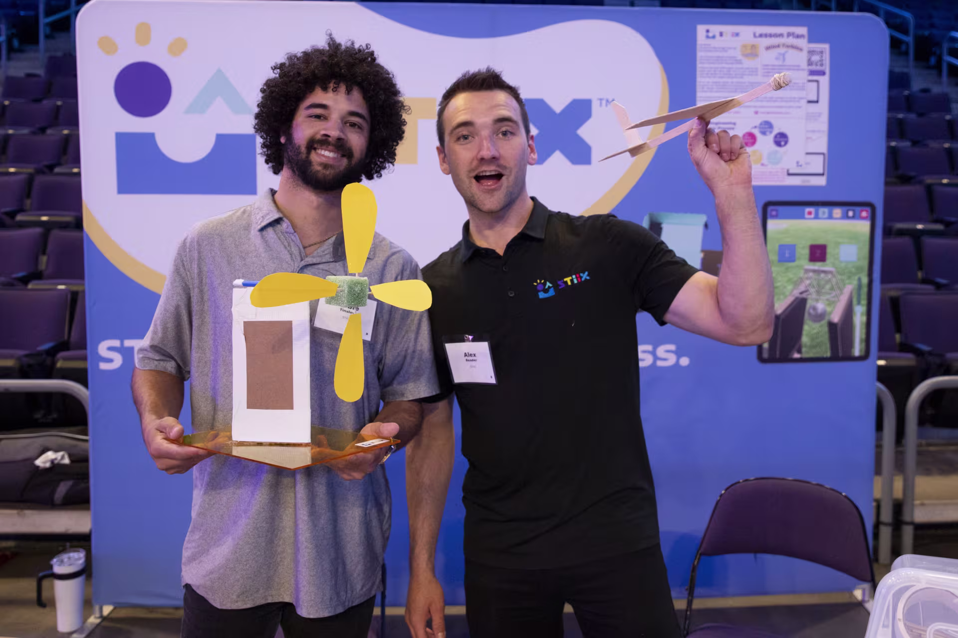 Two STEM students holding up engineering projects