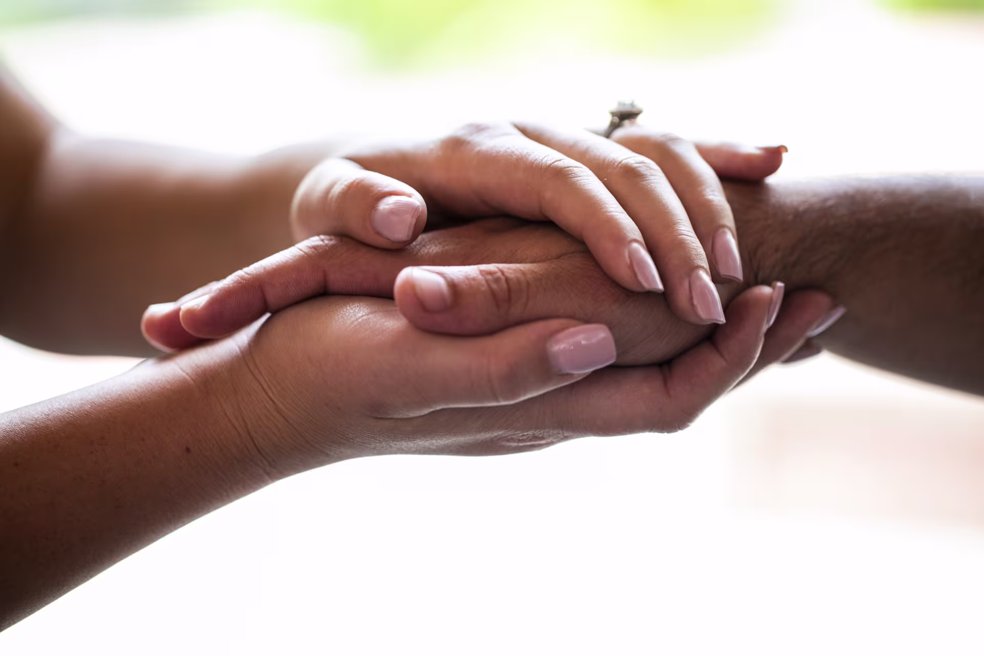 Close up image of two pairs of hands stacked between each other