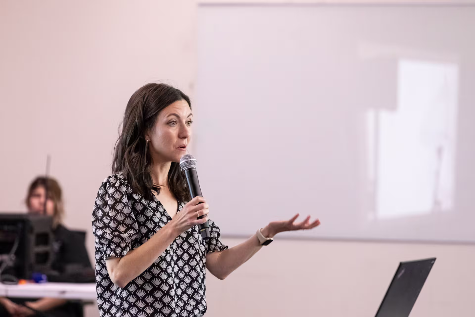 woman-with-microphone-speaking-at-seminary