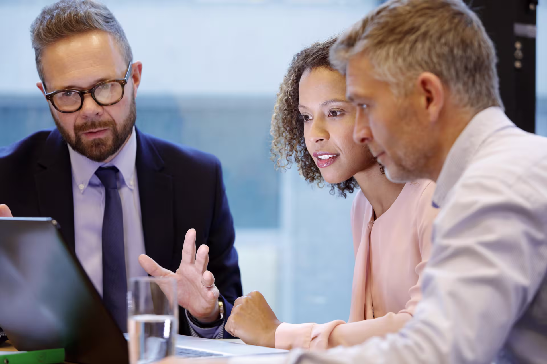 group-of-financial-planners-looking-at-laptop