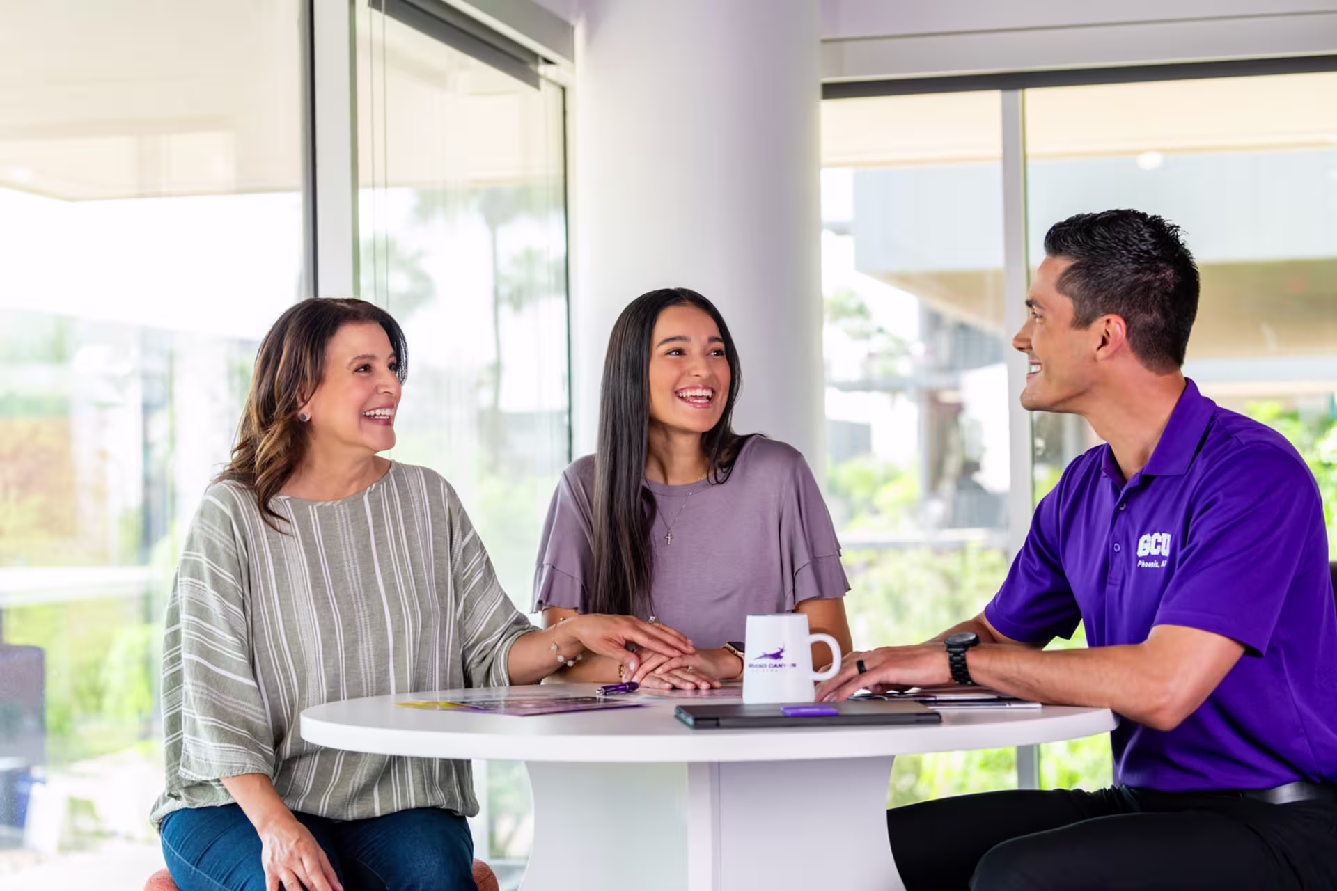 A student in a GCU purple shirt discussing learning goals of the MS in Mental Health and Wellness program.