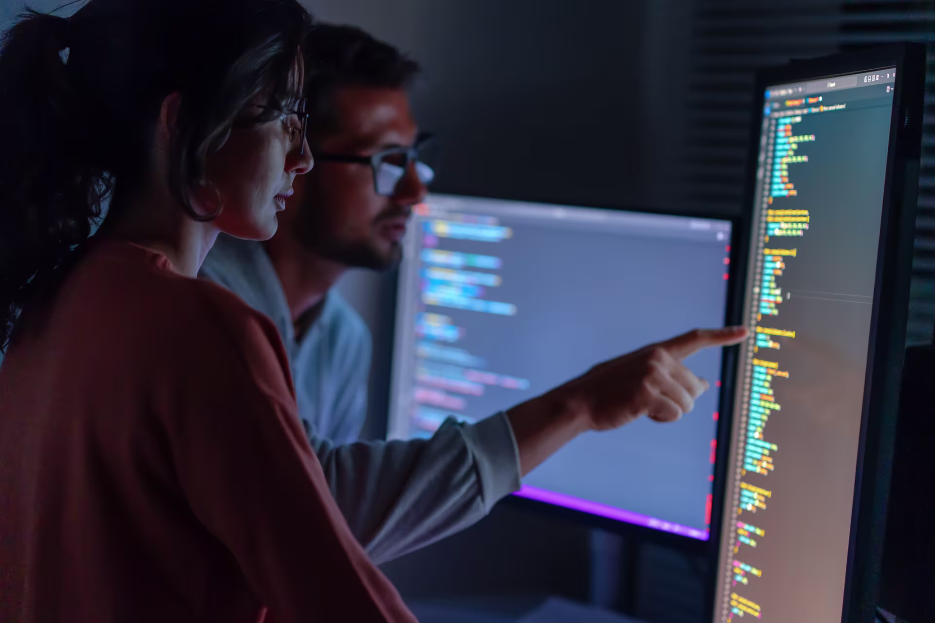two students looking at computer coding screen