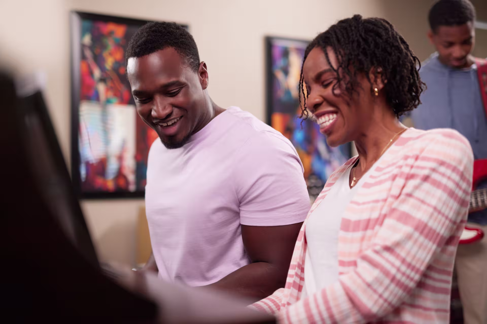 Two people enjoying a music teaching session, highlighting education-focused music programs.