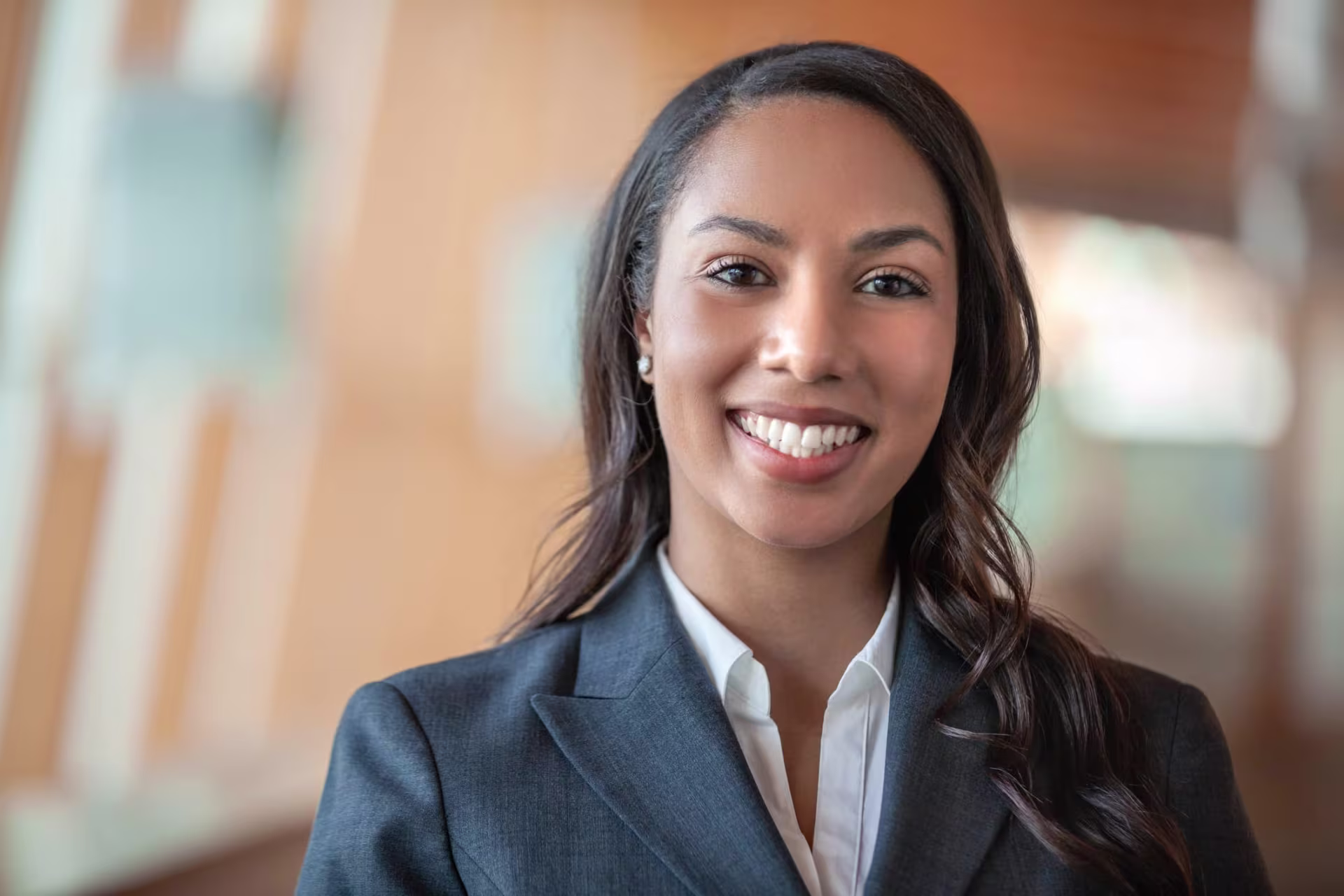 A black woman in a suit smiling as she gets ready to start her MPA program at GCU.