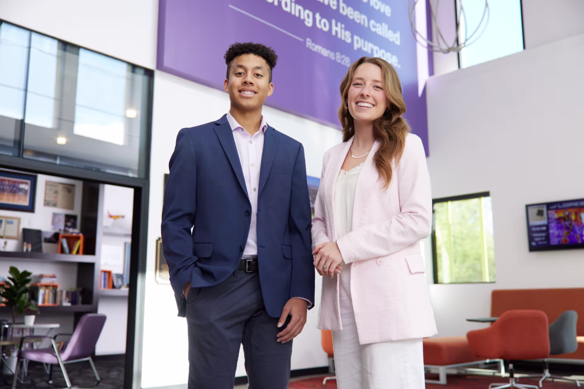 two business students in business attire stand in the ccob building