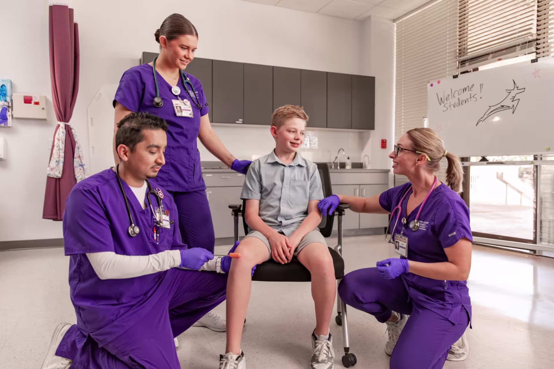 two female and one male nursing students practice child assessment