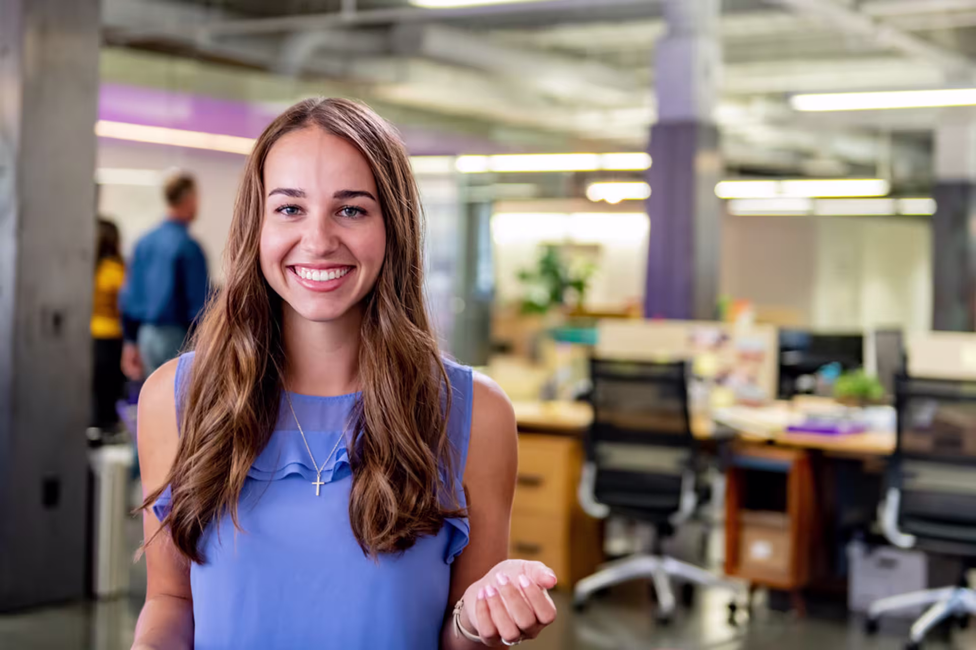 brunette girl smiles big in marketing firm office for internship