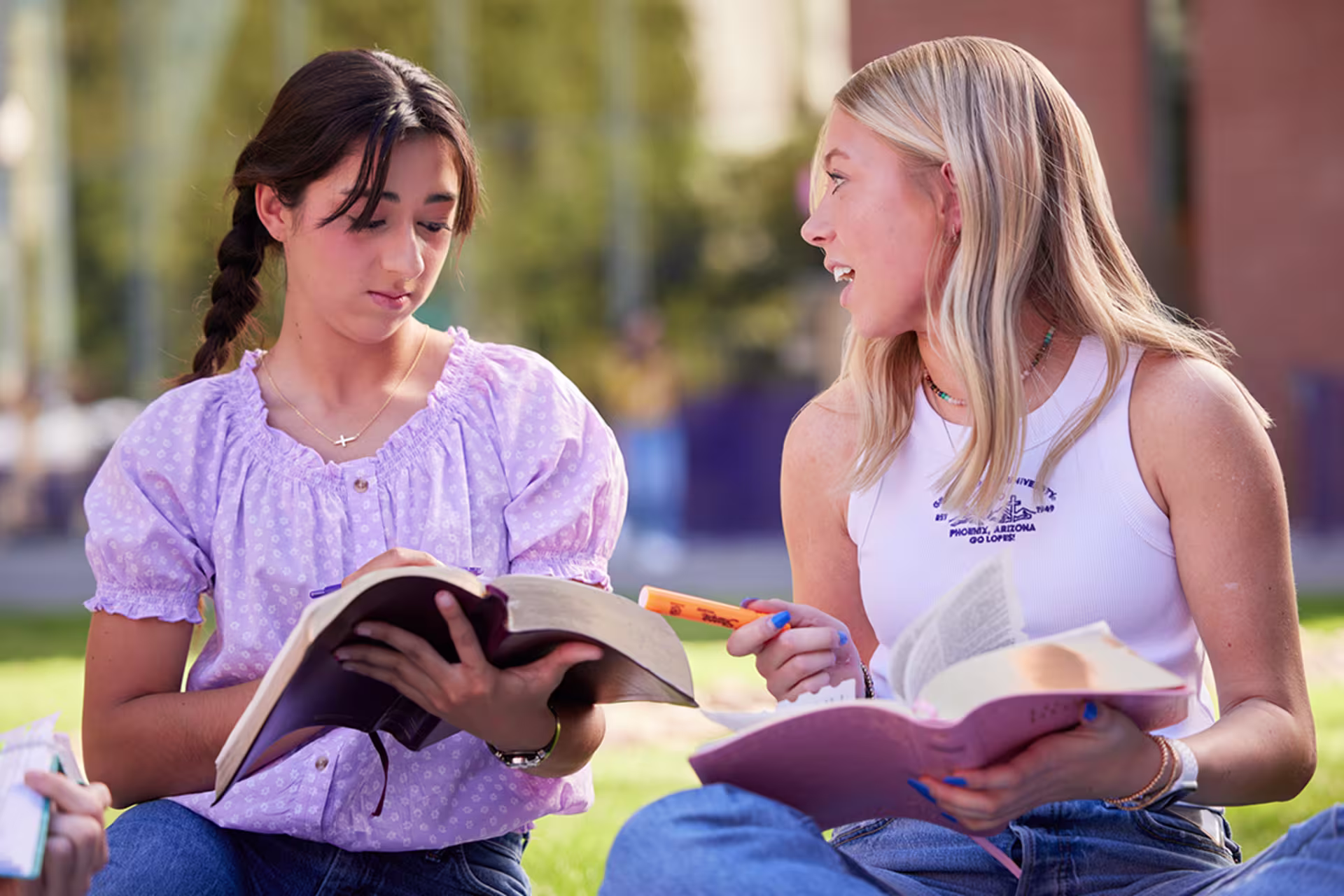 Female COT minor students outside studying bible readings