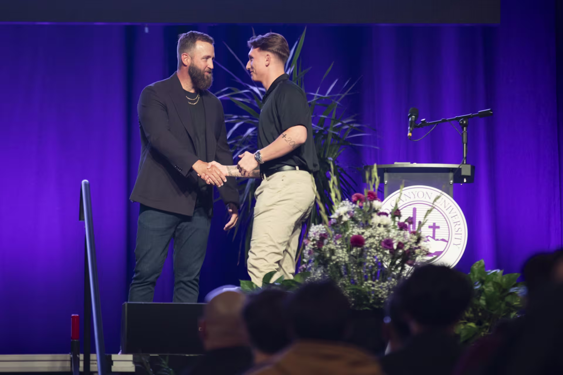 student on stage going to recieve an award