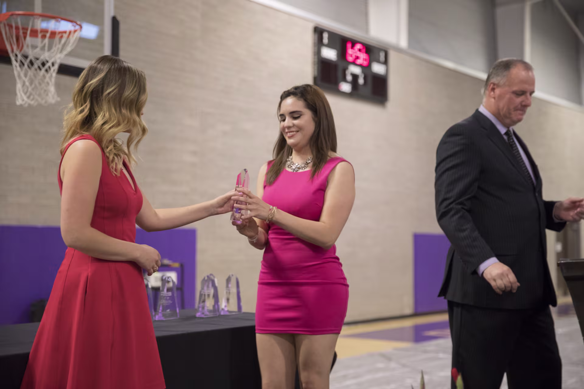 student receiving an award in the gym
