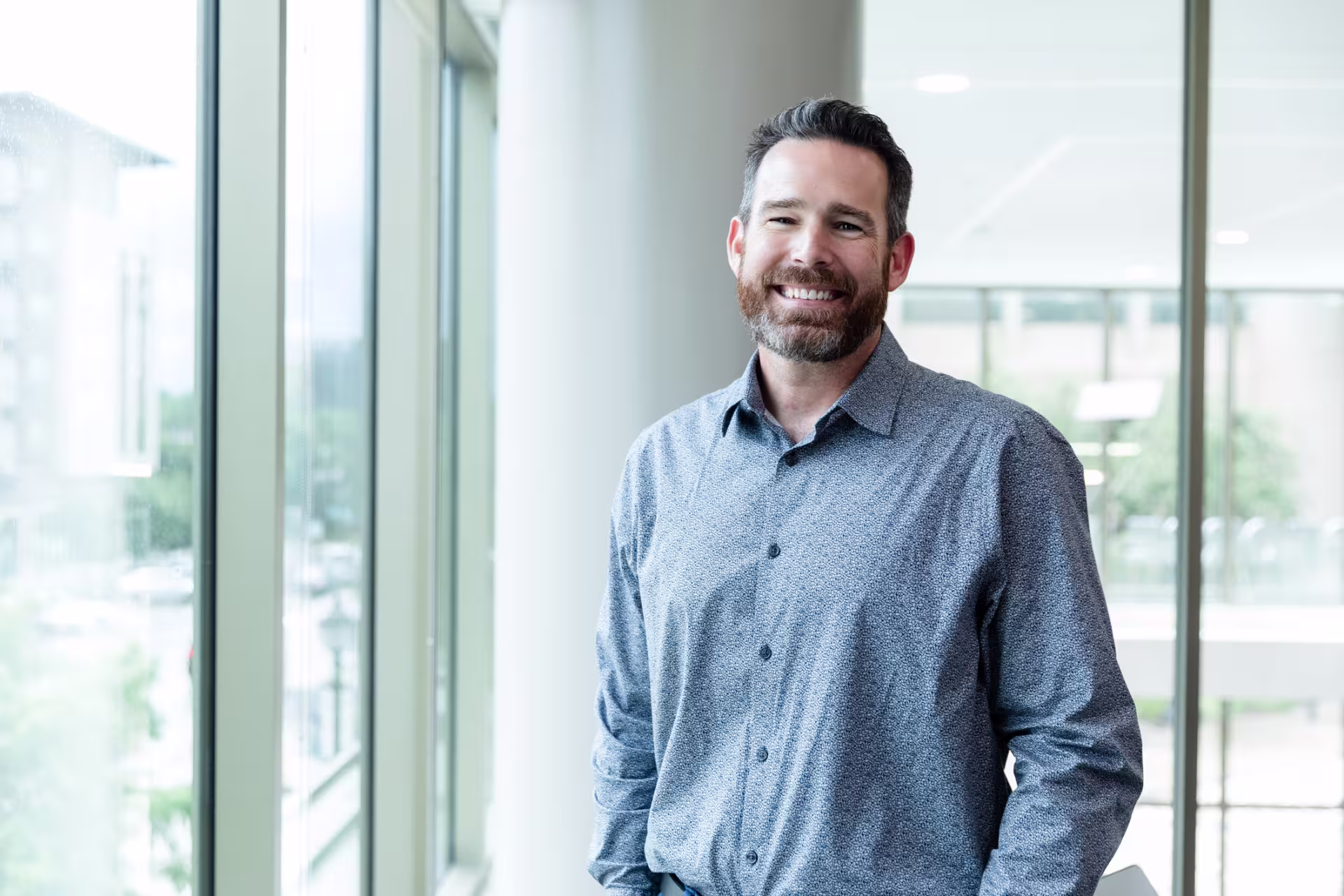 Principal standing next to a pole inside