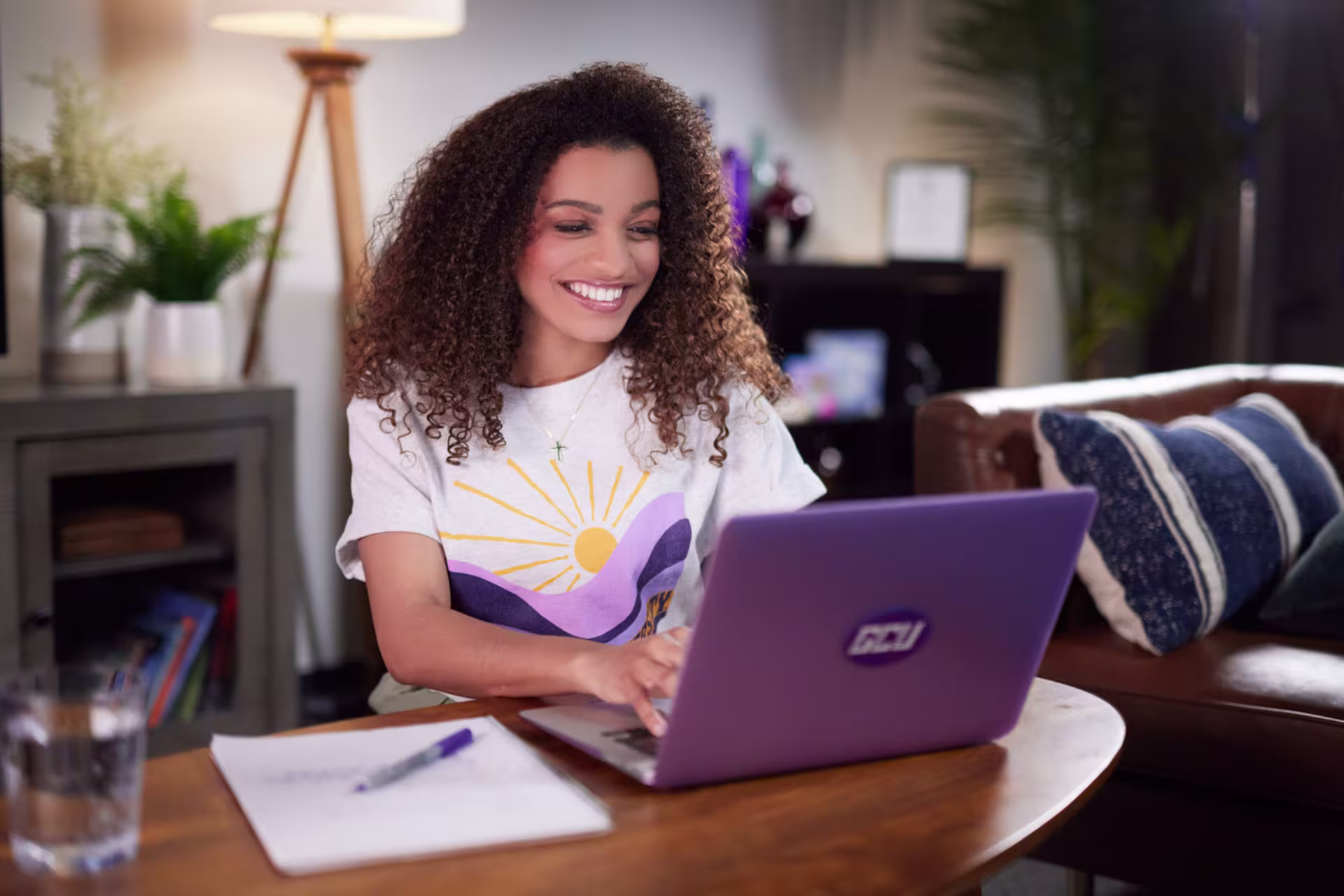 Woman sitting at coffee table and earning online technology degree