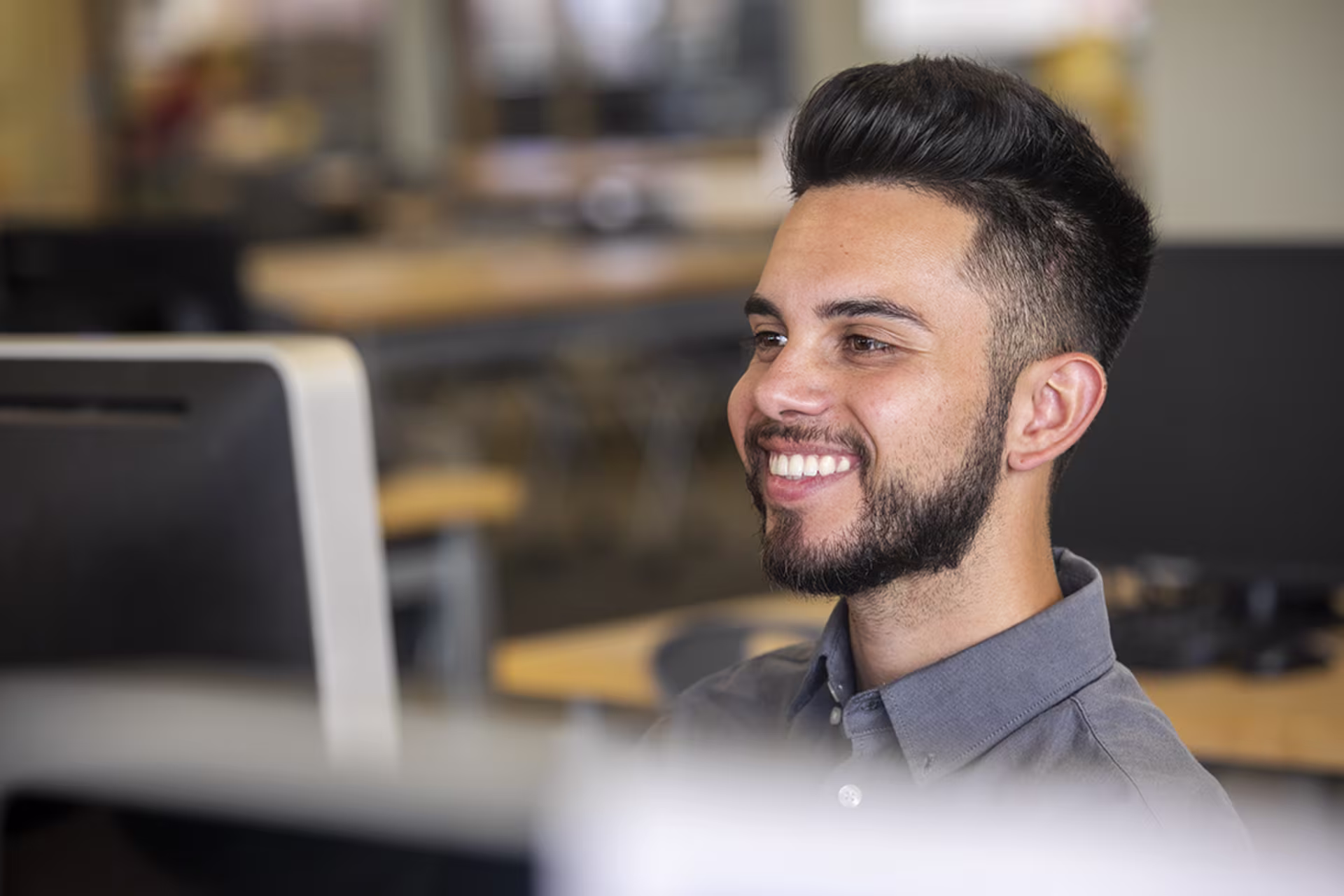 Male DBA student working on computer