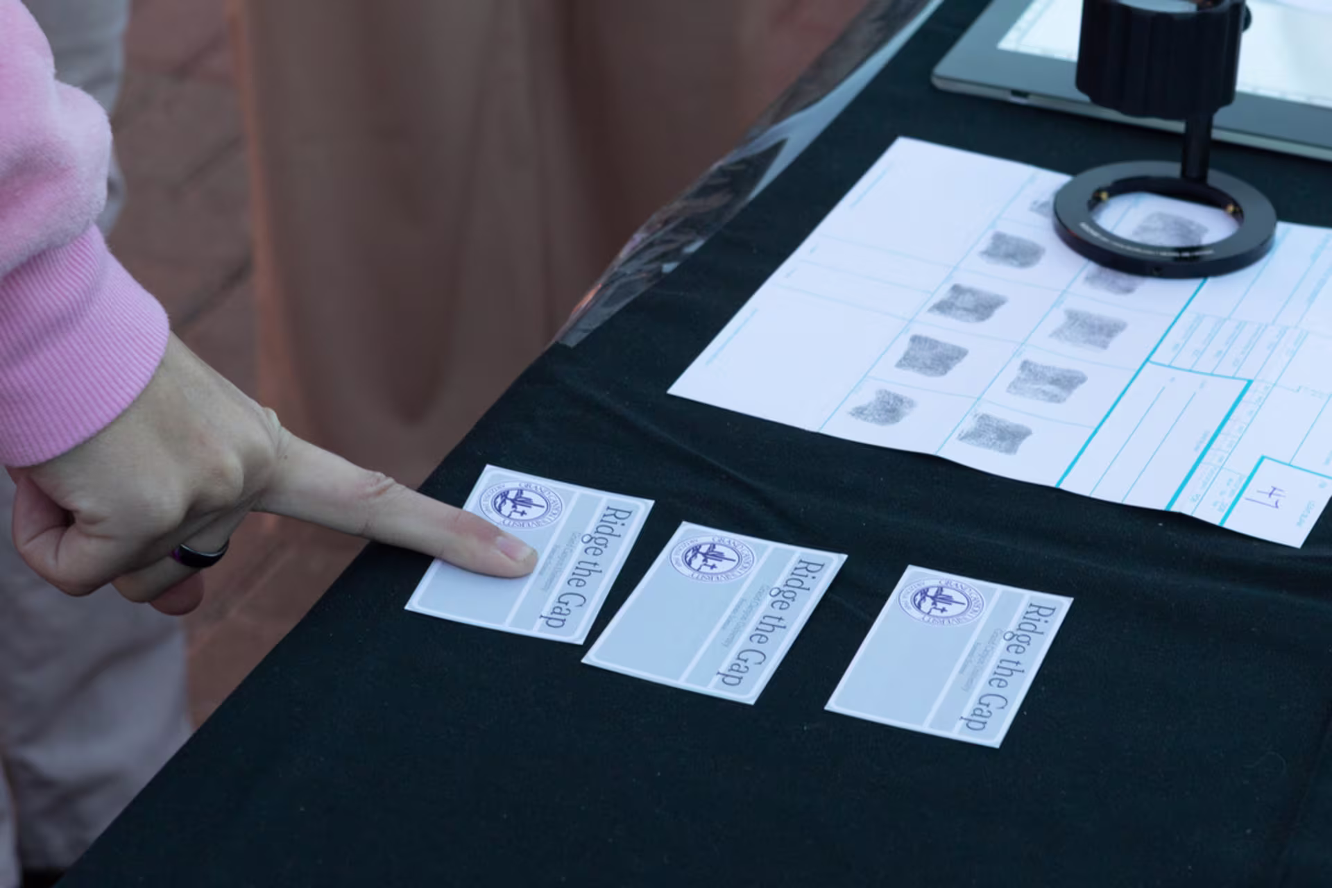 students make fingerprint impressions at fingerprint booth at gcu forensic science day