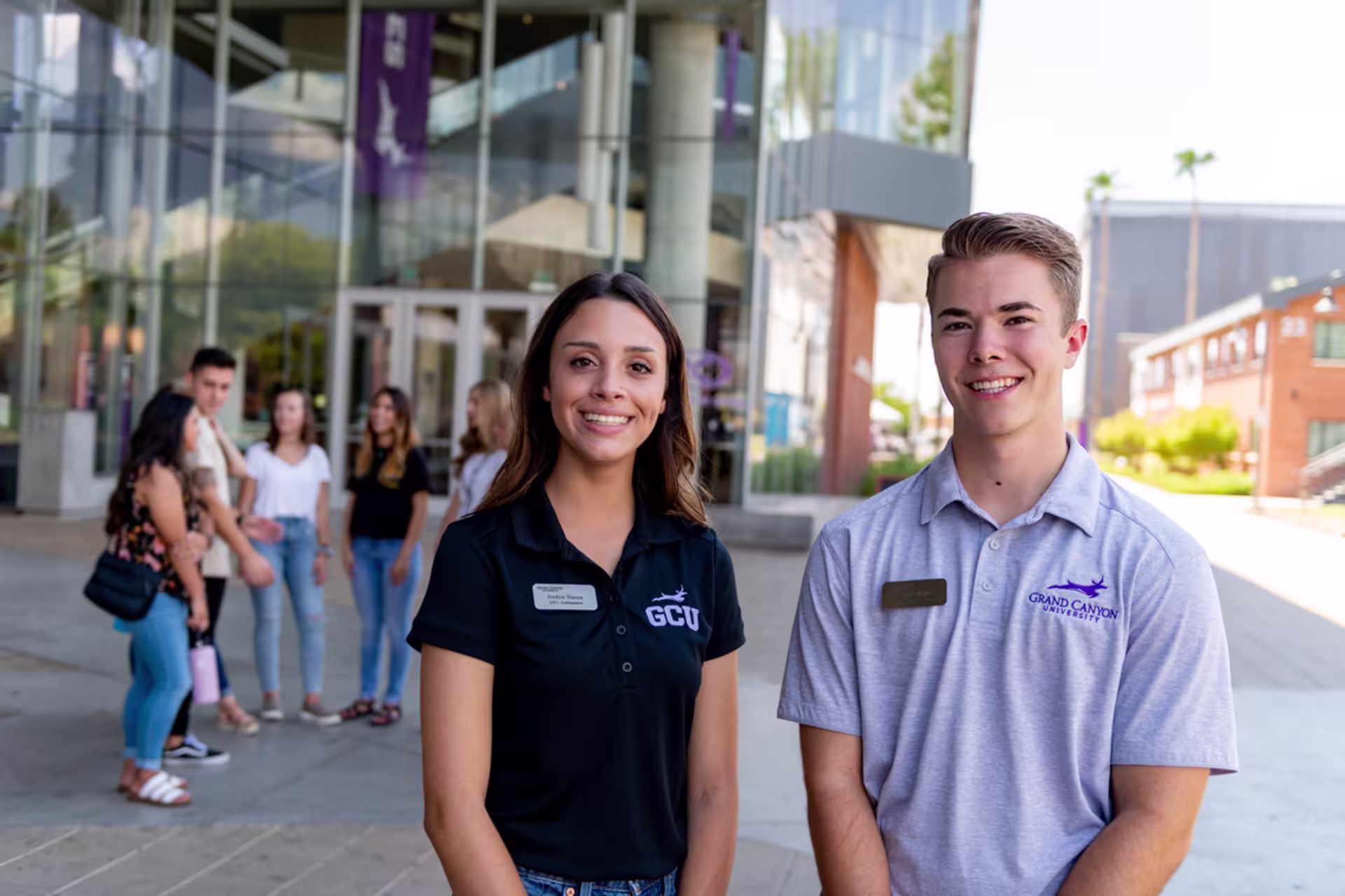 Two students smiling as they give a tour of GCU’s campus.