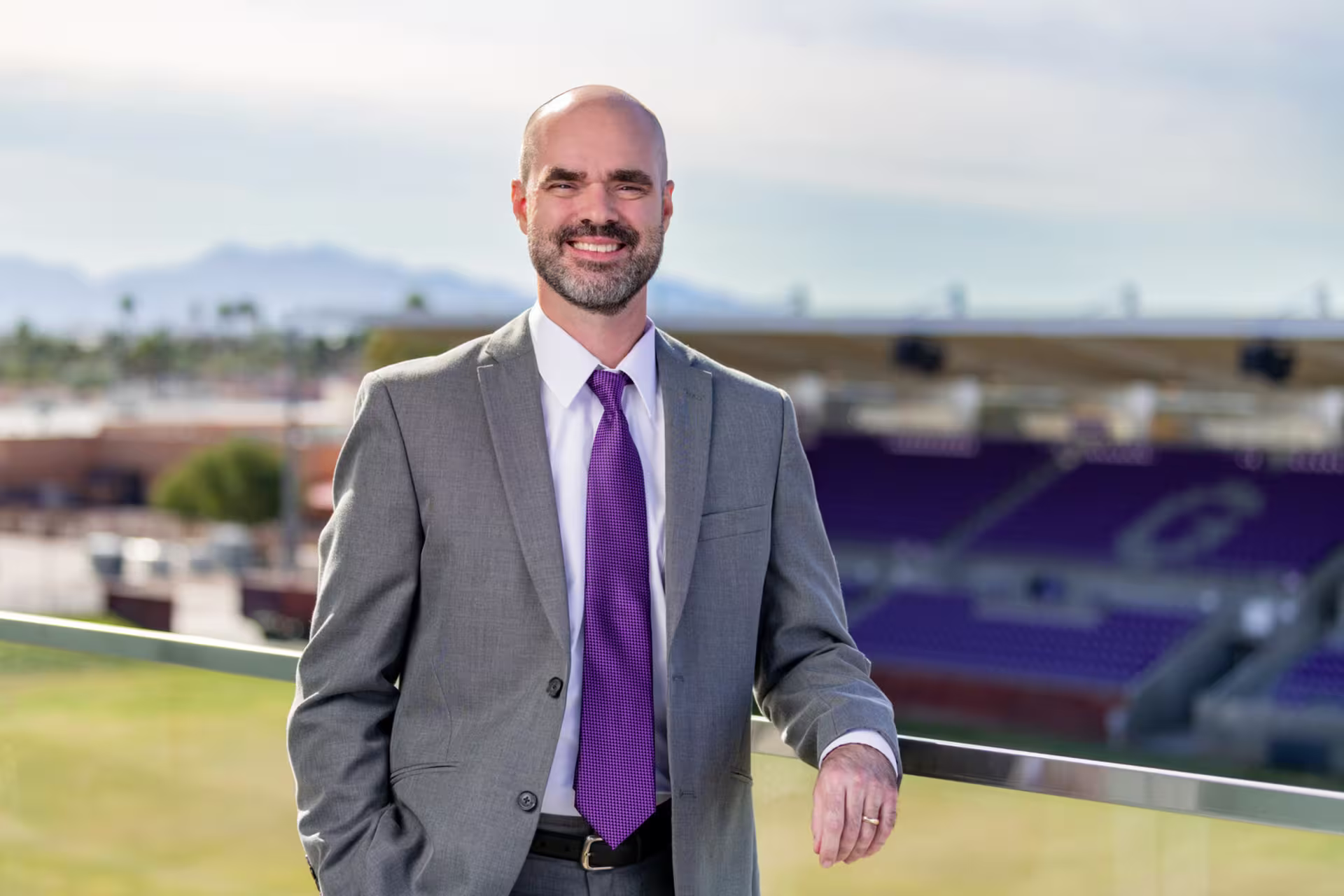 Headshot of Ray Kaselonis standing outside college baseball stadium.