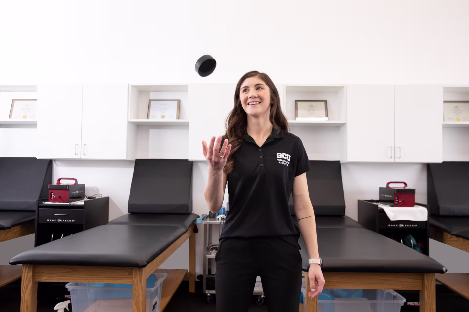 GCU's occupational therapy assistant throwing up ball in clinic
