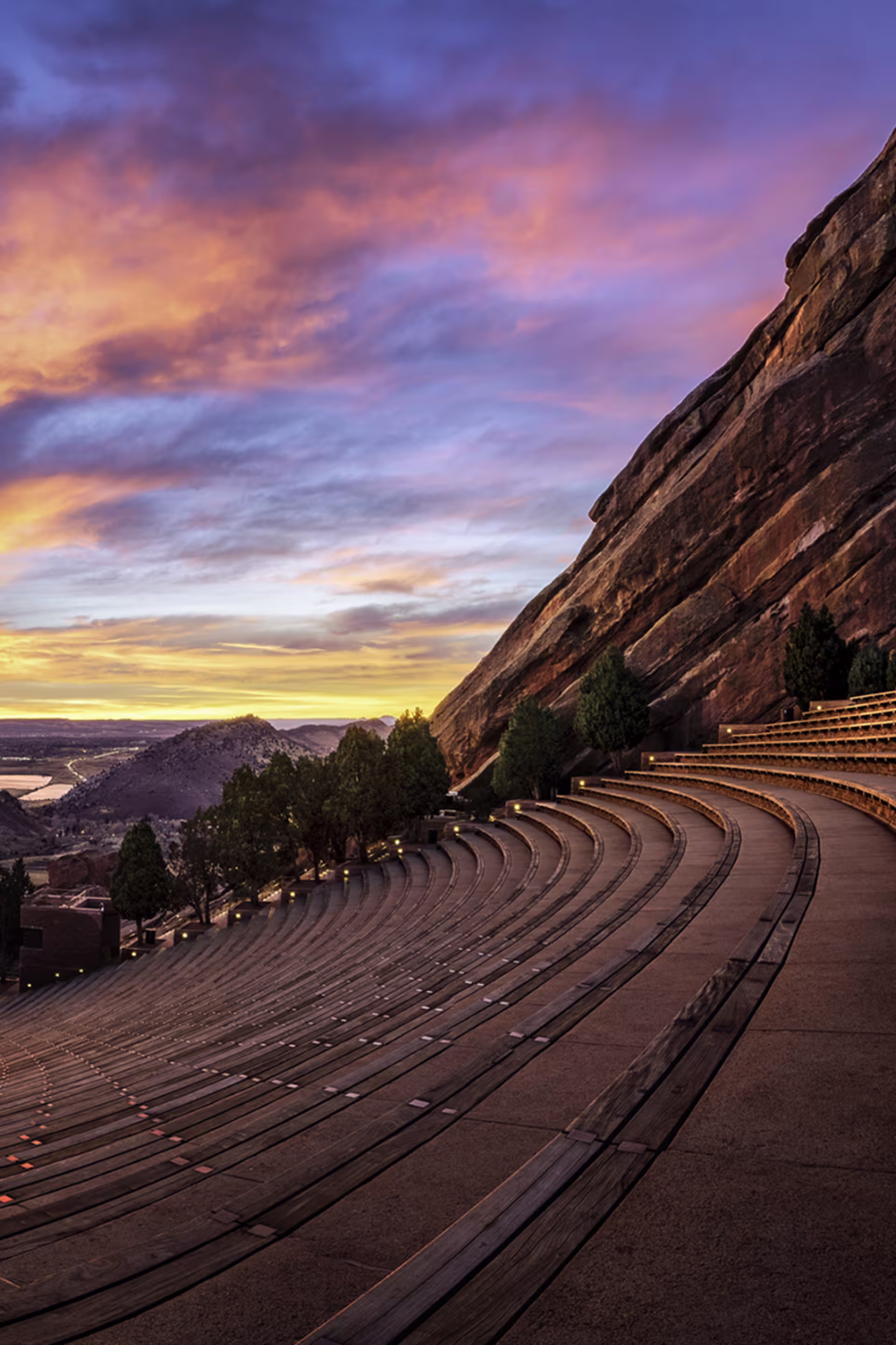 portrait view of the red rocks amphitheater at sunrise with colorful sky