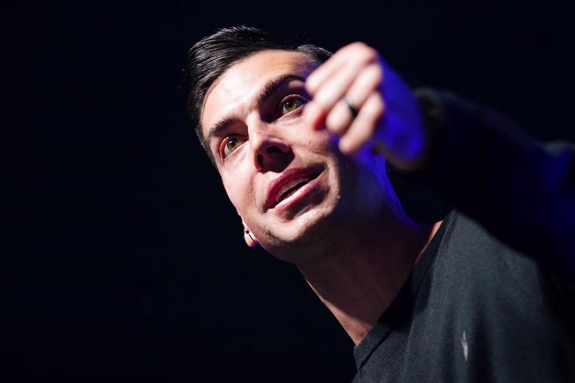 Man speaks passionately with fist raised