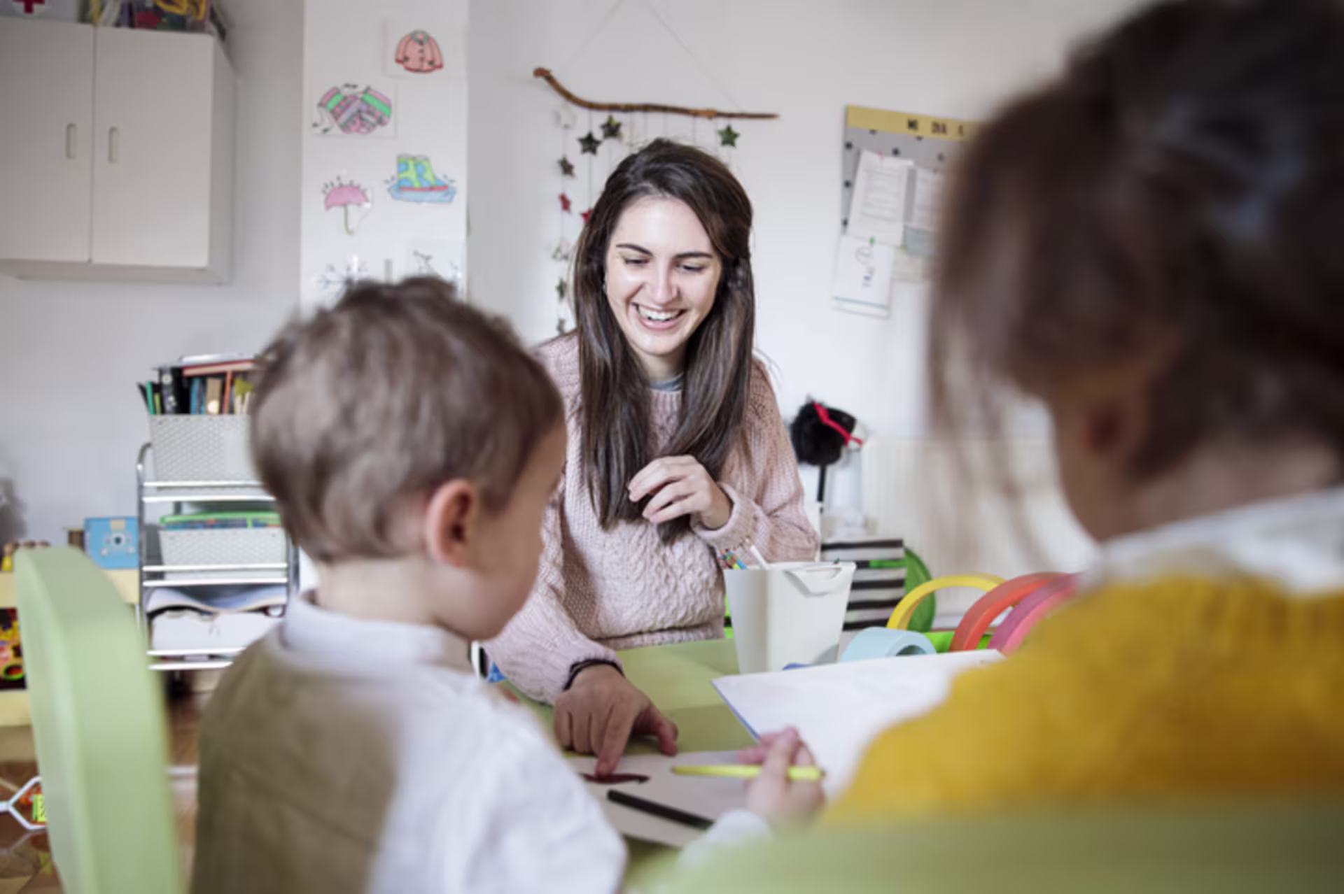 Female teacher showing children the benefits of rubrics