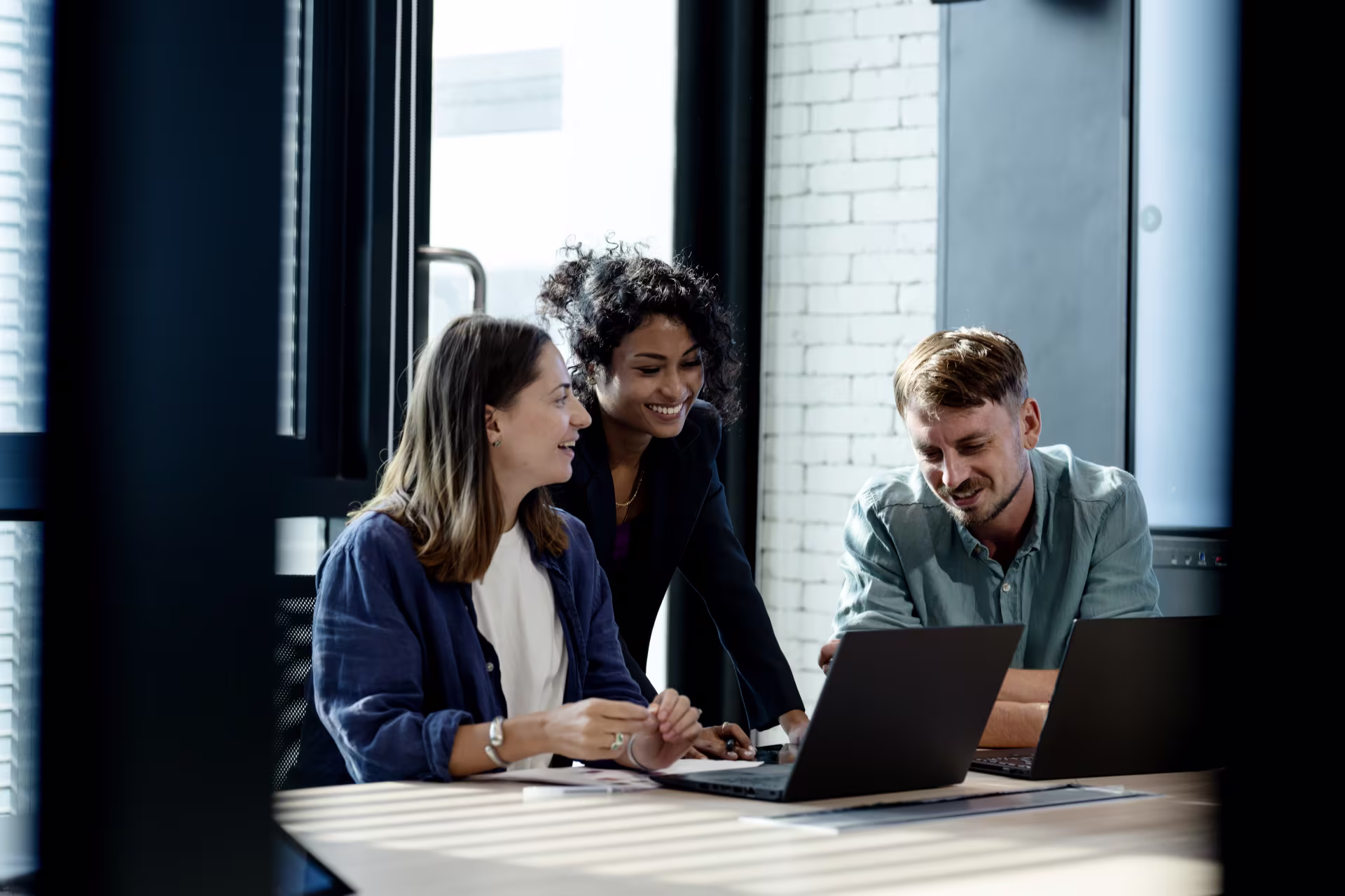 people surrounding computer at work