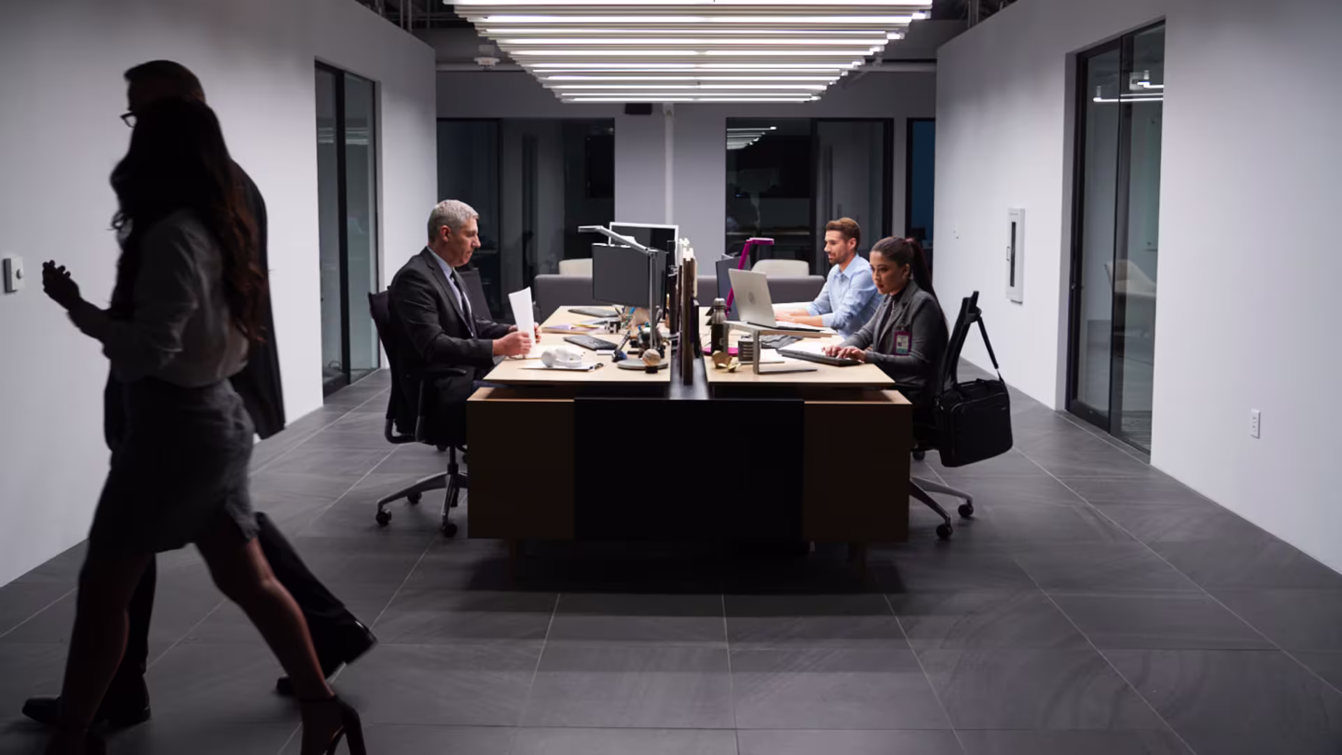 People sit at computers in office meeting setting