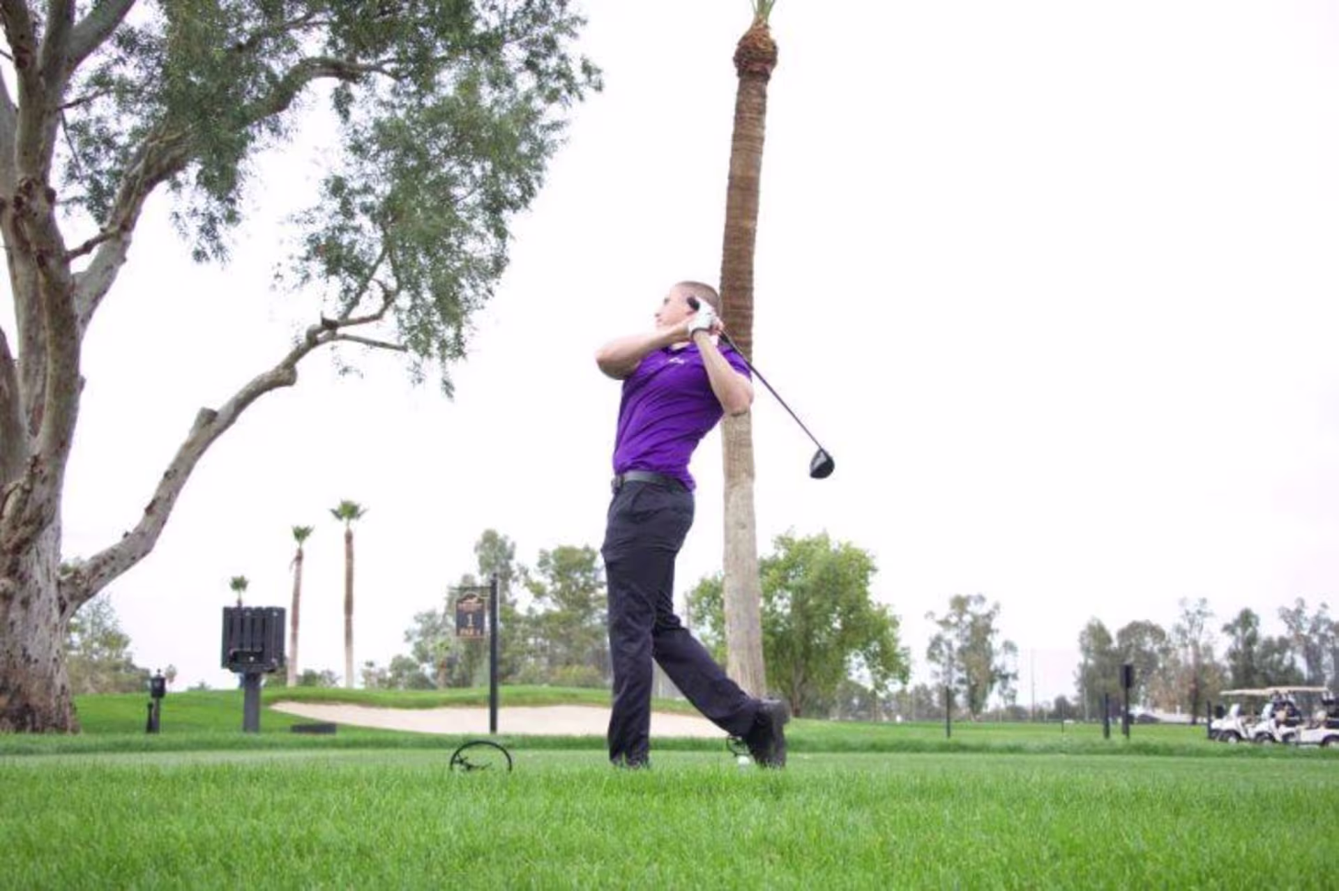 A student athlete playing golf