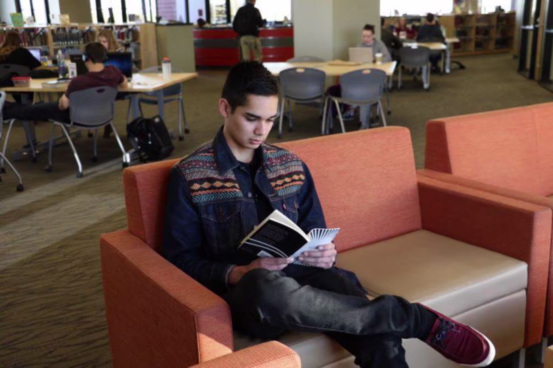 A GCU student reading in the library