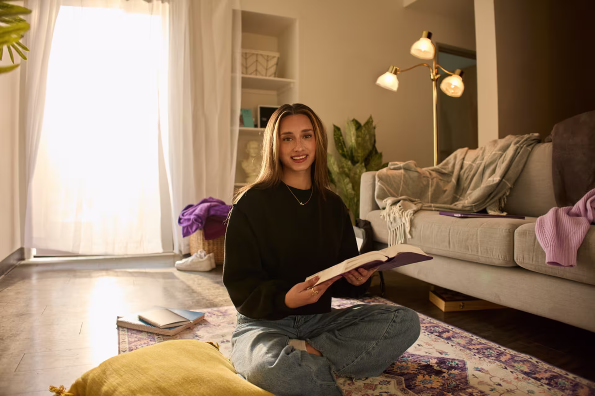 Female Christian studies degree student reading Bible in her home.