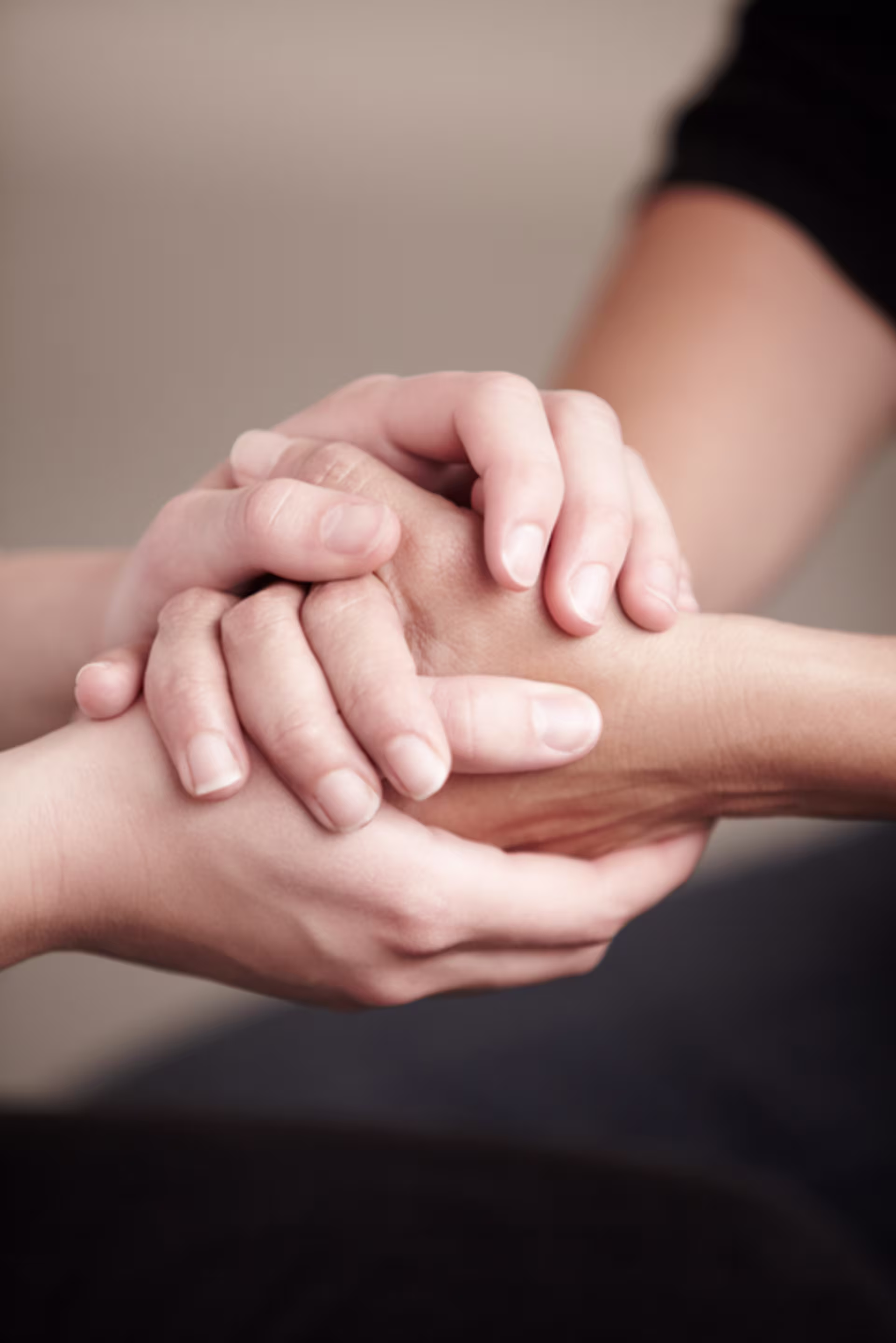 Women holding hands in prayer