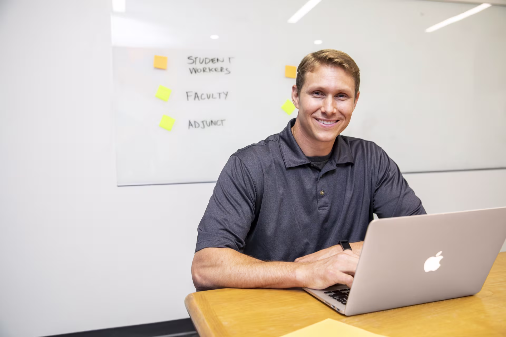 Guy sitting at table with laptop.