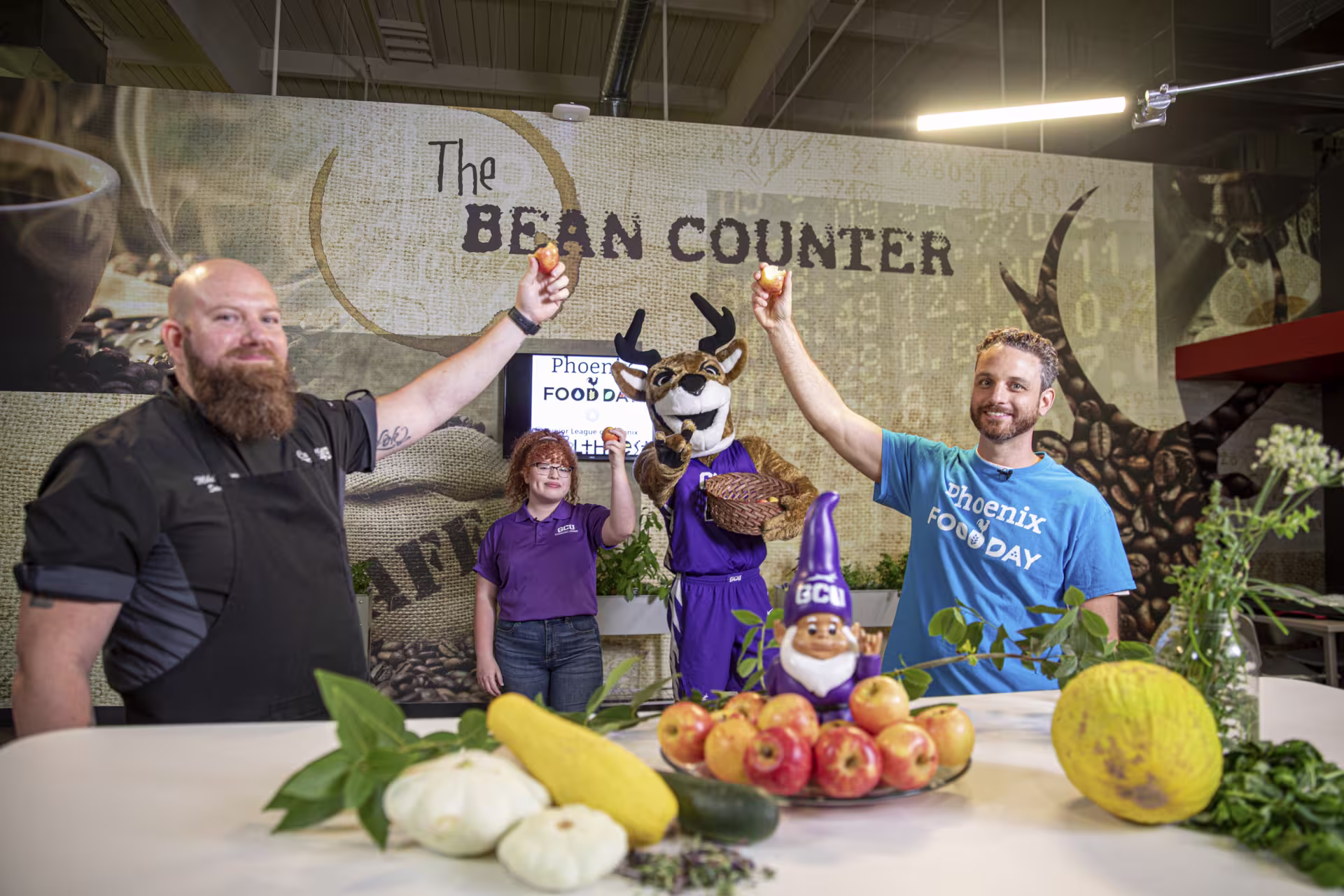 Chefs and restaurant employees holding food in air with GCU’s Thunder mascot