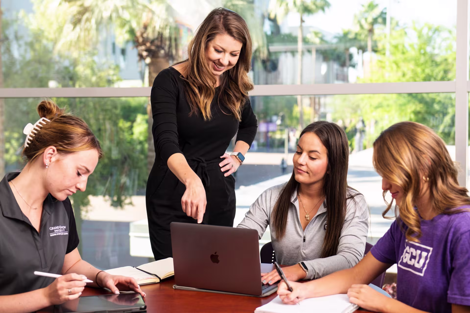 Faculty working together in a meeting room.