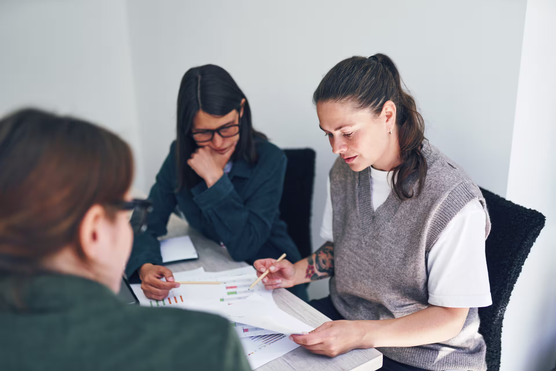 Educational administrators collaborating over reports in a conference room.