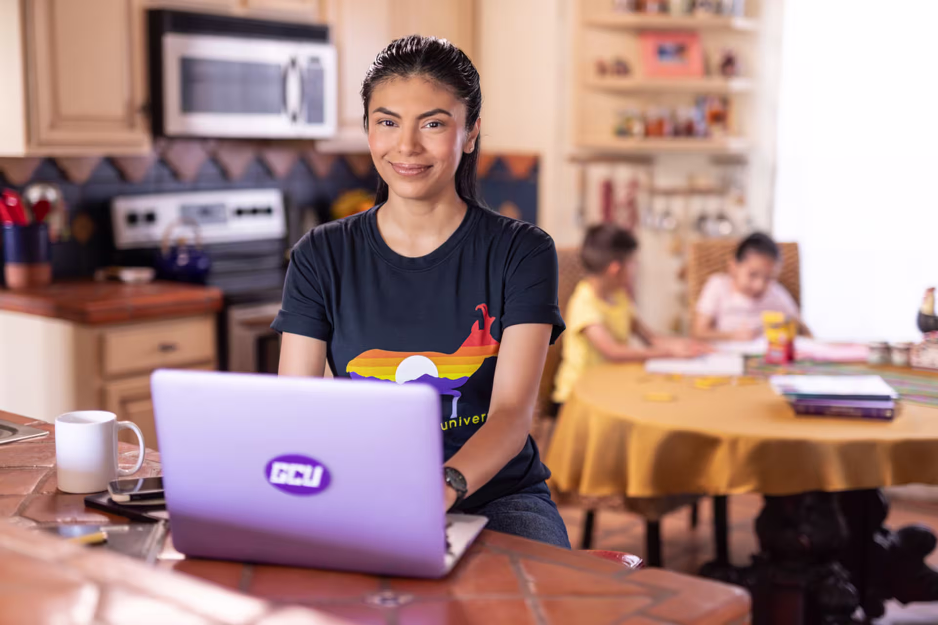 Female pre-nursing online student completing coursework on a purple laptop from home.
