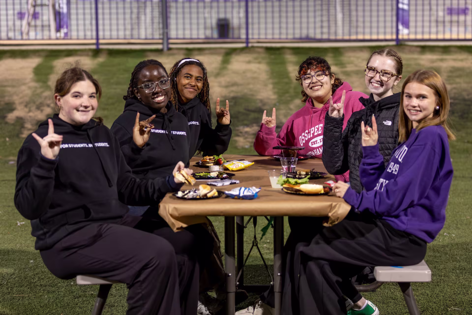 GCU students enjoying a meal together outdoors, highlighting flexible meal plan options and a social campus dining experience.