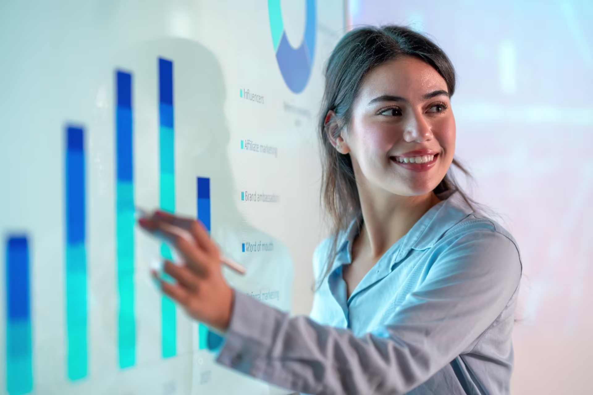 A professional presents risk management data on a digital dashboard with bar charts, analyzing performance metrics and financial risk trends in a corporate setting.