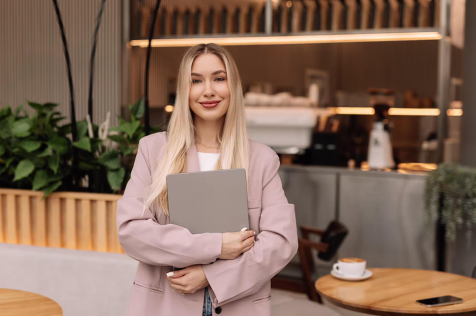Female advanced graduate certificate in marketing student holding a tablet in a professional setting.