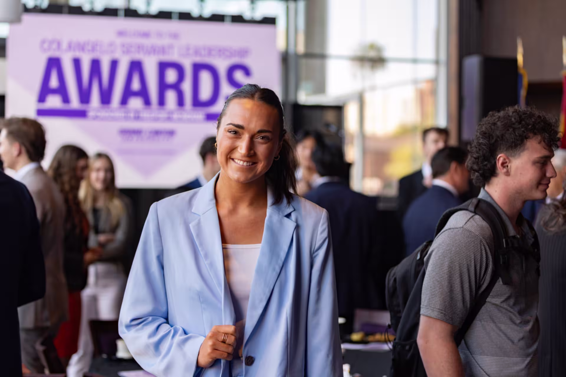 A female GCU business student wearing a blazer smiles and looks at the camera.