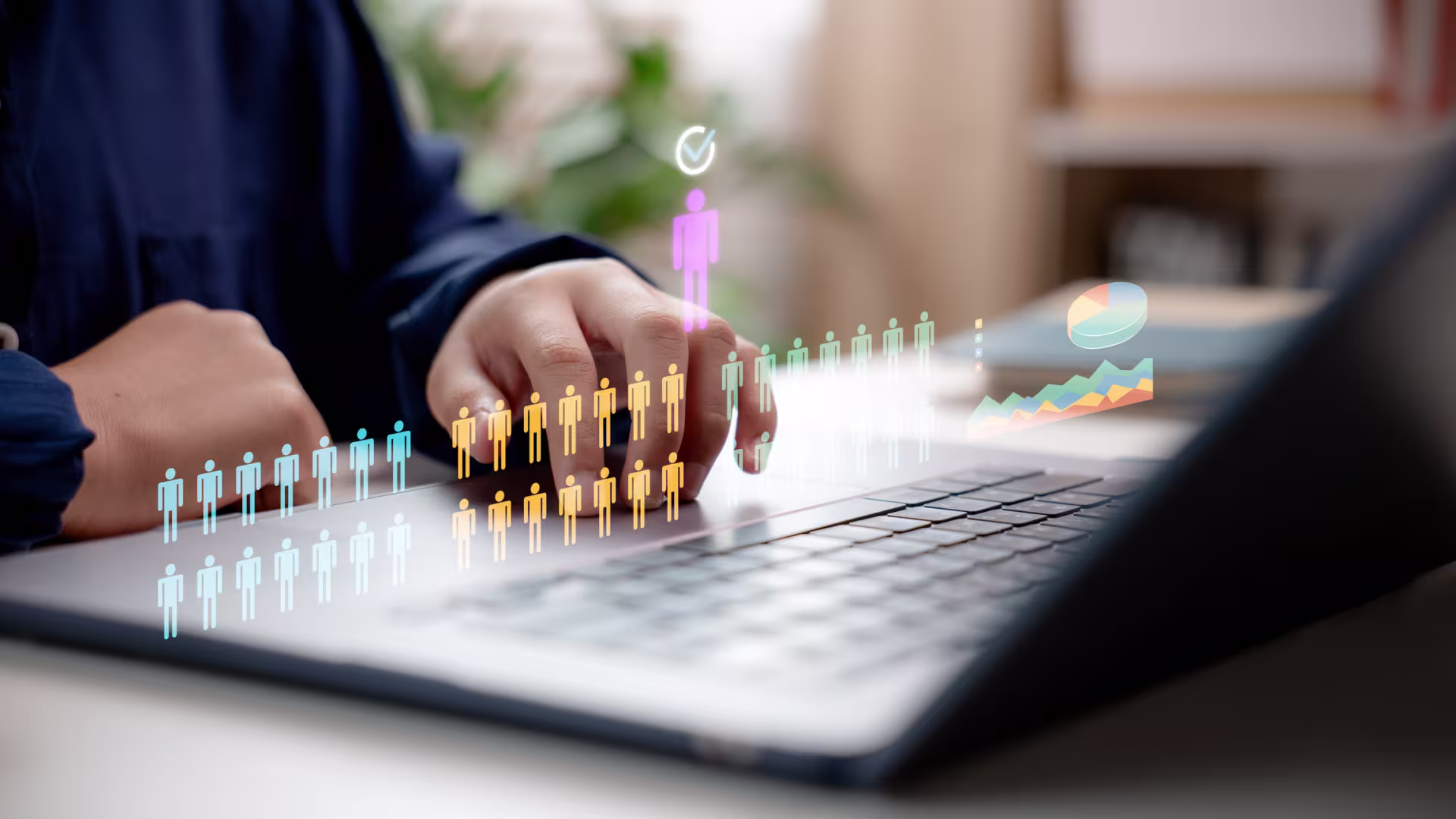 Hands using a laptop with digital workforce analytics icons, candidate selection graphic, and performance charts displayed as an augmented reality overlay.