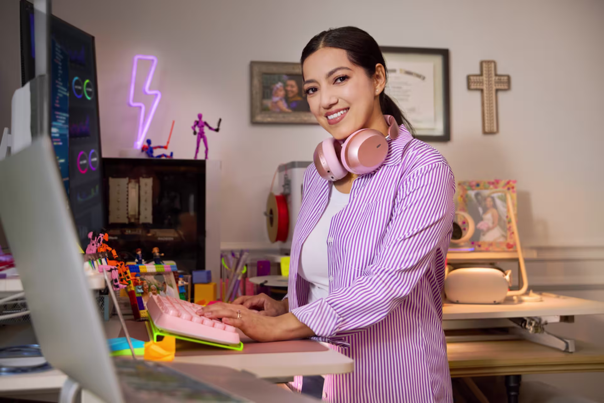 A cybersecurity student works at a desktop computer in a home office.