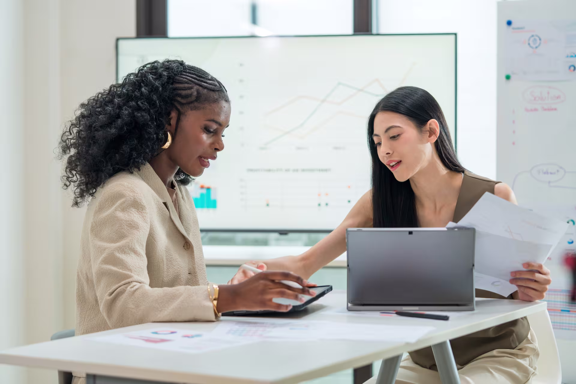 Finance professionals review financial reports and data during a planning meeting.