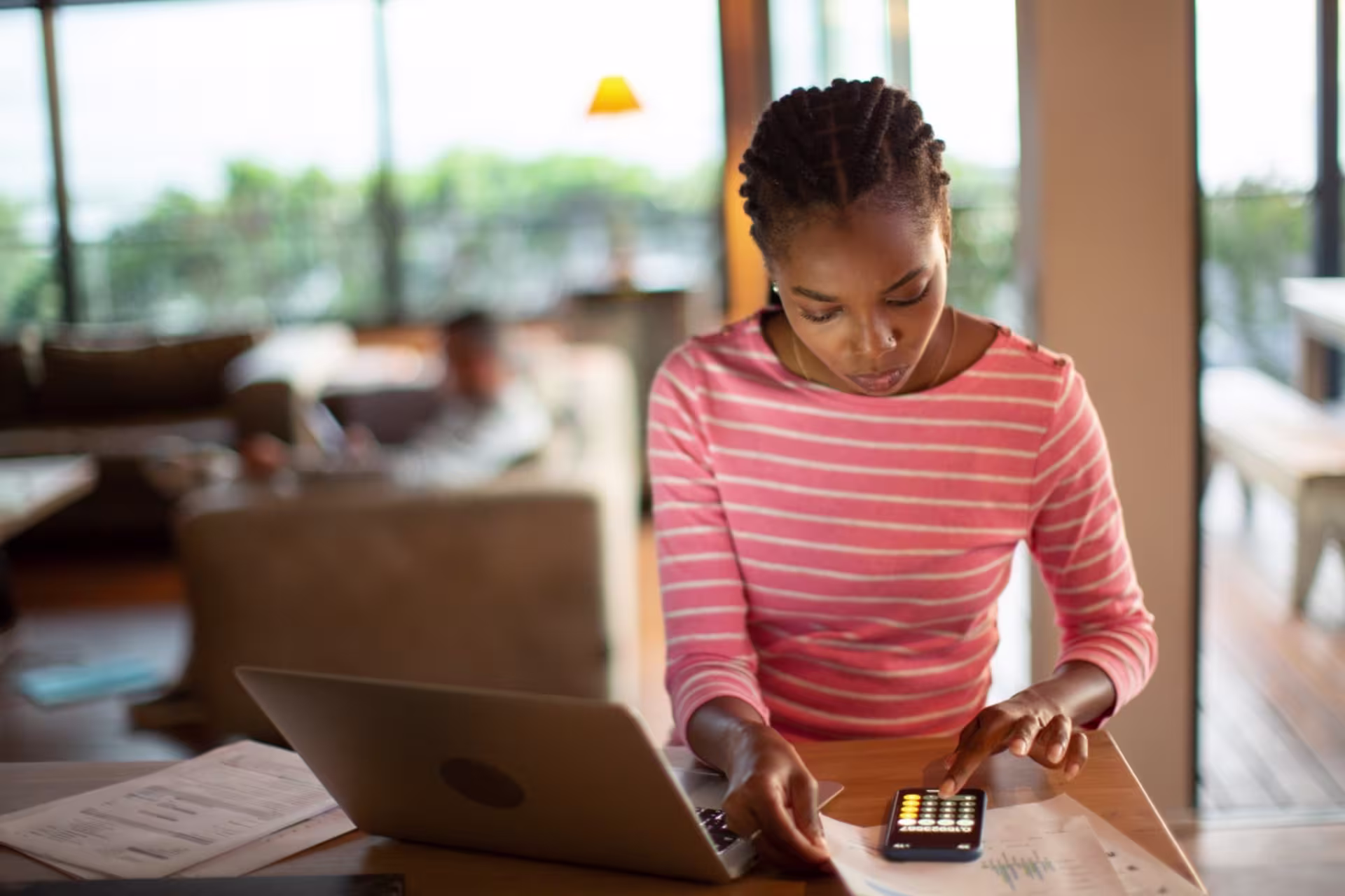 An online data science graduate student reviews educational expenses and tuition planning materials while studying remotely.